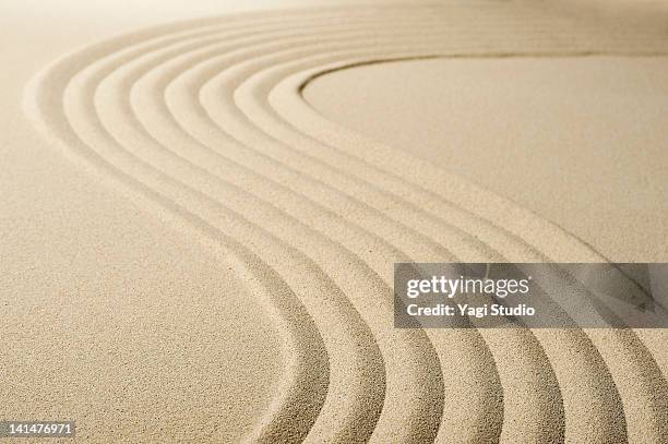 wave pattern in the sandpit - zen sand stock pictures, royalty-free photos & images