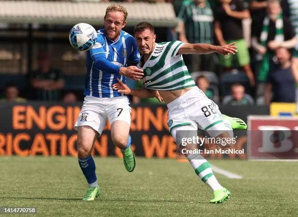 Josip Juranovic of Celtic vies with Rory McKenzie of Kilmarnock during the Cinch Scottish Premiership match between Kilmarnock FC and Celtic FC at on...
