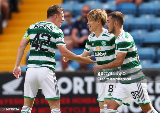 Kyogo Furuhashi of Celtic is congratulated by team mates after scoring the opening goal during the Cinch Scottish Premiership match between...
