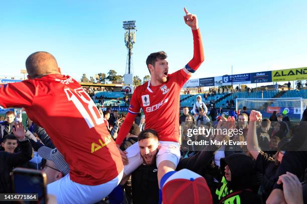 Glen Trifiro and Adrian Vlastelica of Sydney United 58 are held aloft by fans after their win during the Australia Cup Rd of 16 match between Sydney...