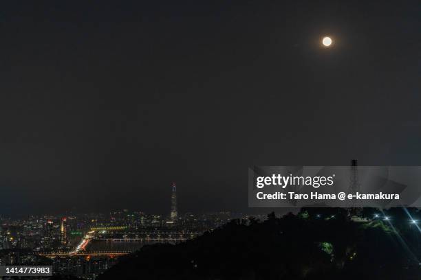 full moon over illuminated seoul city of south korea - namsan seoul stock pictures, royalty-free photos & images