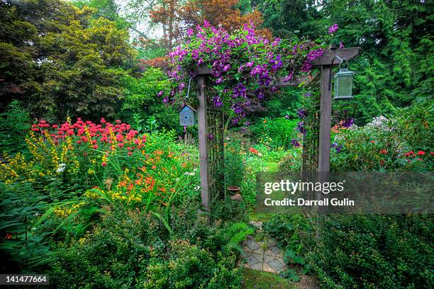 garden and path arbor, colors of summer - pergola fotografías e imágenes de stock