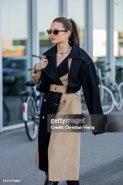 Emilie Billington seen wearing two tone beige black denim trench coat outside Munthe during Copenhagen Fashion Week Spring/Summer 2023 on August 11,...