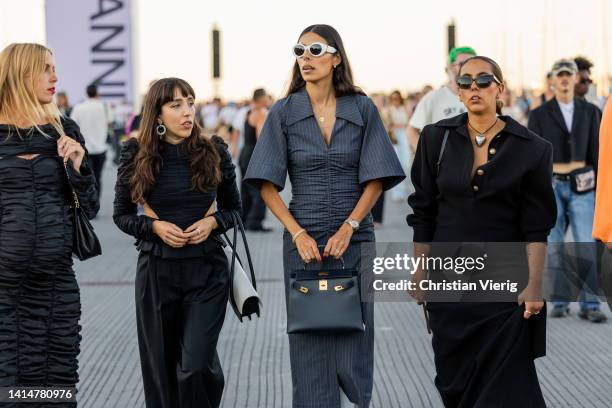Guests seen wearing grey, black outside Ganni during Copenhagen Fashion Week Spring/Summer 2023 on August 11, 2022 in Copenhagen, Denmark.