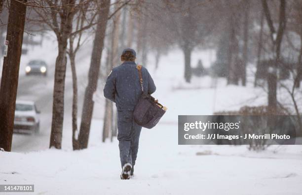 mail man in snow storm - postal worker stock pictures, royalty-free photos & images