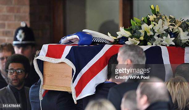 The coffin of Pc David Rathband is carried into Stafford Crematorium at his funeral on March 17, 2012 in Stafford, England. PC Rathband who was shot...