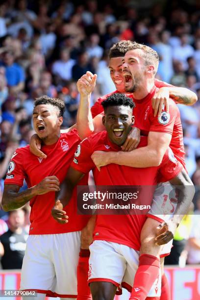 Taiwo Awoniyi of Nottingham Forest celebrates with team mates after scoring their sides first goal during the Premier League match between Nottingham...