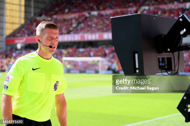Match referee Robert Jones checks a VAR screen during the Premier League match between Nottingham Forest and West Ham United at City Ground on August...