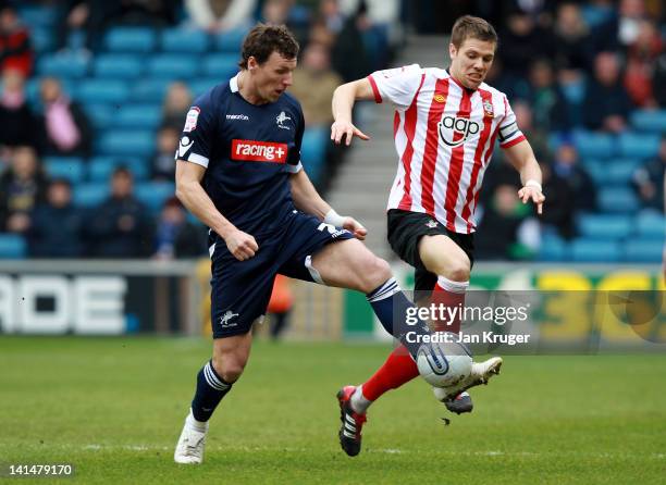 Darius Henderson of Millwall competes with Dean Hammond of Southampton during the npower Championship match between Millwall and Southampton at The...