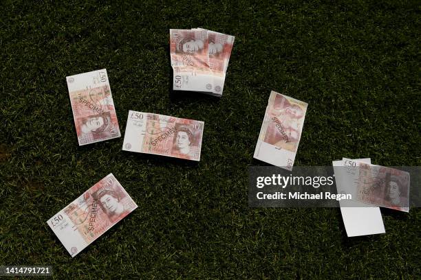 Fake money is seen on the pitch after being thrown by West Ham United fans during the Premier League match between Nottingham Forest and West Ham...