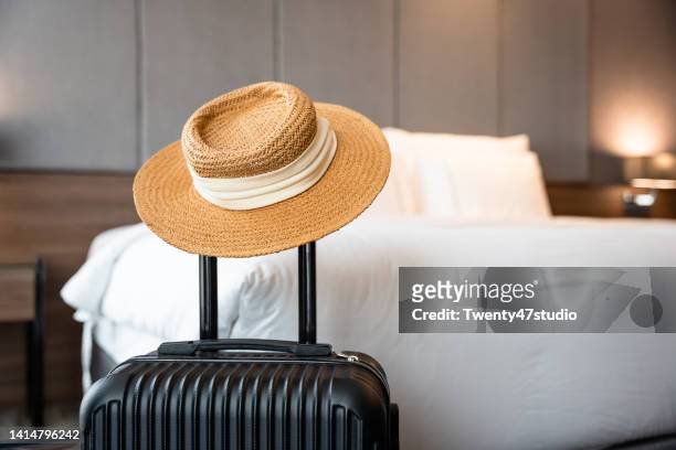 a suitcase in luxury hotel room - sun hat stock pictures, royalty-free photos & images