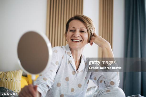 senior woman in bed. - women short hair stock pictures, royalty-free photos & images