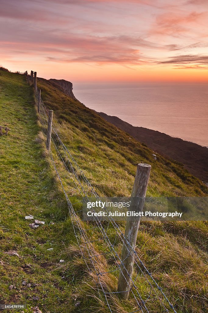 Looking over a fence to the coastline of Dorset.