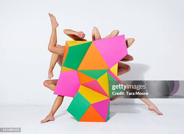 arms and legs emerging from abstract shape