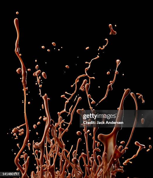 chocolate splashing in air - chocolat liquide stock pictures, royalty-free photos & images