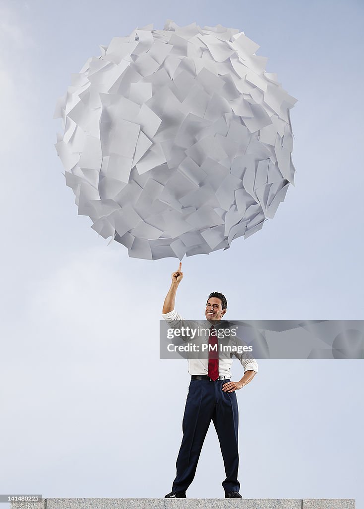 Businessman with big ball of paper