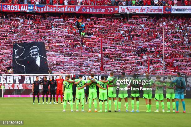 Players, officials and fans take part in a minute of silence in memory of FC Bayern Munchen president Willi O. Hoffmann prior to the Bundesliga match...