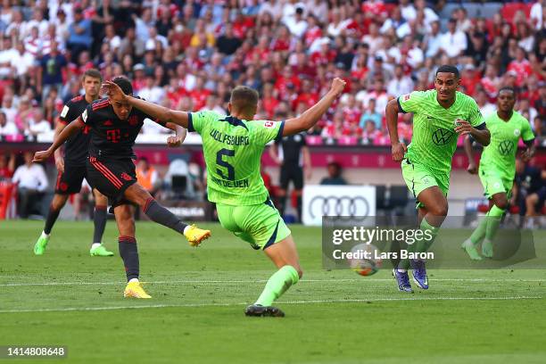 Jamal Musiala of Bayern Munich scores their sides first goal during the Bundesliga match between FC Bayern München and VfL Wolfsburg at Allianz Arena...