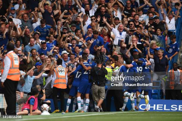 Reece James of Chelsea (obscured celebrates with team mates and fans after scoring their sides second goal during the Premier League match between...