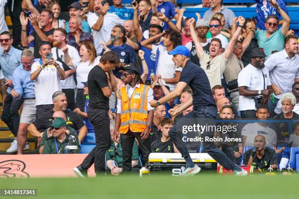 Head Coach Thomas Tuchel runs past Head Coach Antonio Conte of Tottenham Hotspur celebrating after Reece James of Chelsea scores a goal to make it...
