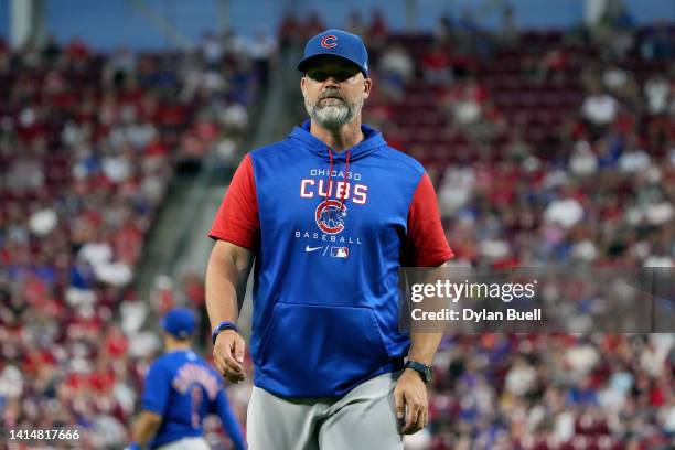 Manager David Ross of the Chicago Cubs walks across the field after making a pitching change in the fifth inning against the Cincinnati Reds at Great...