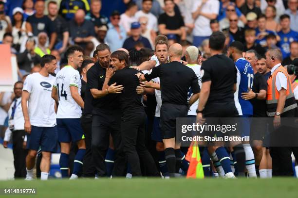 Antonio Conte, Manager of Tottenham Hotspur is held back prior to being shown a red card after the Premier League match between Chelsea FC and...