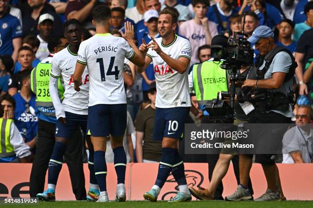 Harry Kane of Tottenham Hotspur celebrates with team mates after scoring their sides second goal during the Premier League match between Chelsea FC...