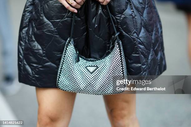 Miki Cheung wears black quilted puffy large shorts, a black leather with embroidered rhinestones handbag from Prada, outside Baum und Pferdgarten,...