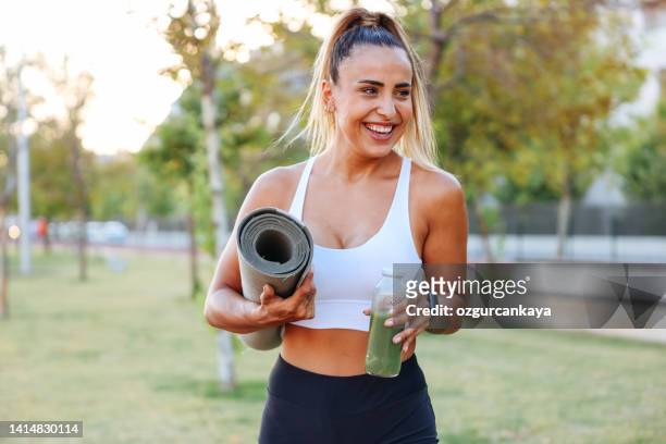 woman drinking vegetable smoothie after fitness running workout - smoothies stock pictures, royalty-free photos & images