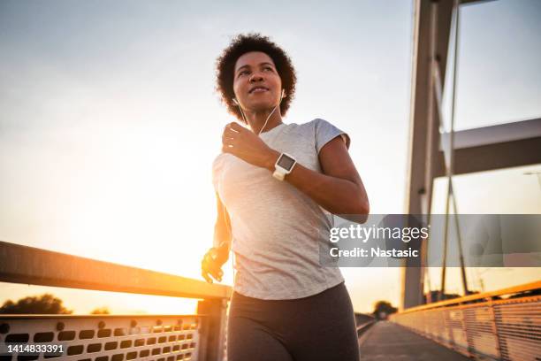 young african american woman jogging - woman headphones sport smile iphone stock pictures, royalty-free photos & images