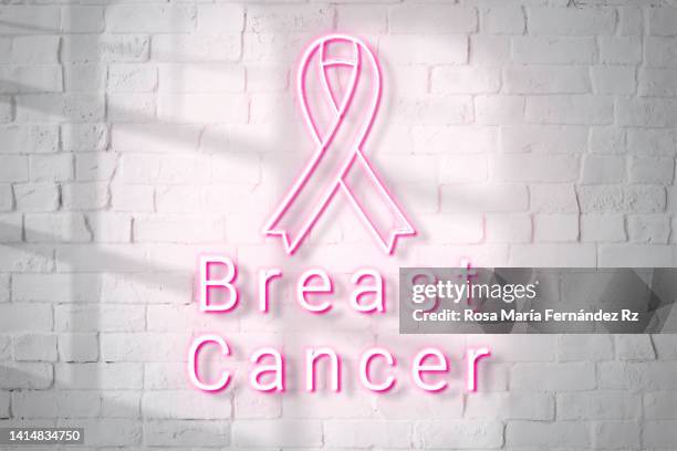 neon emboss logo breast cancer - oncology abstract stock pictures, royalty-free photos & images