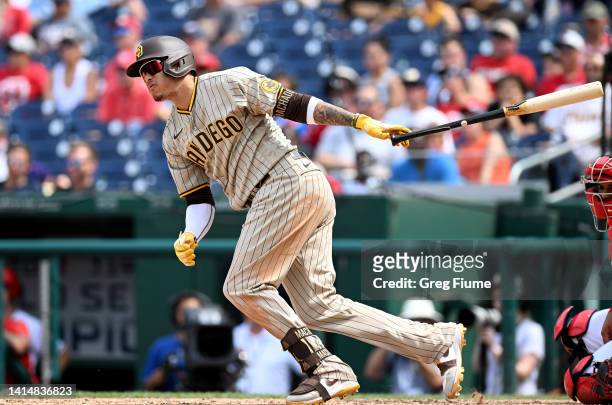 Manny Machado of the San Diego Padres hits a single in the ninth inning against the Washington Nationals at Nationals Park on August 14, 2022 in...