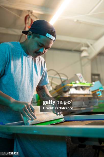 portrait of paolo screen printing manually pulling paint - silk screen stock pictures, royalty-free photos & images