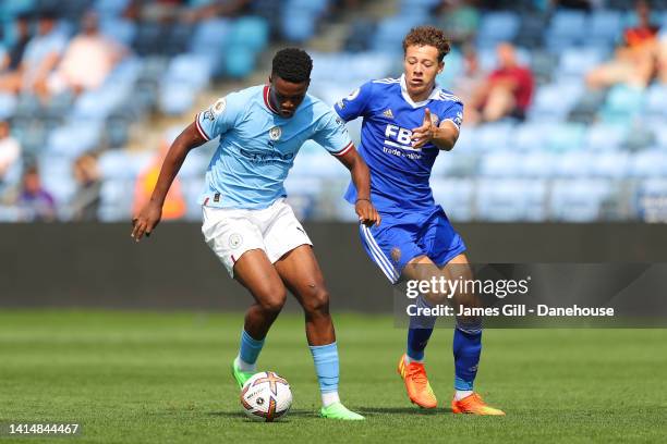 Daniel Ogwuru of Manchester City battles for possession with Kasey McAteer of Leicester City during the Premier League 2 match between Manchester...