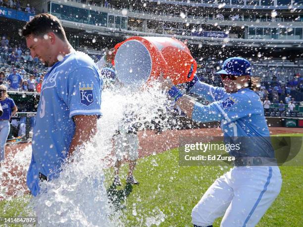Vinnie Pasquantino of the Kansas City Royals is doused with water by Bobby Witt Jr. #7 as they celebrate a 4-0 win over the Los Angeles Dodgers at...