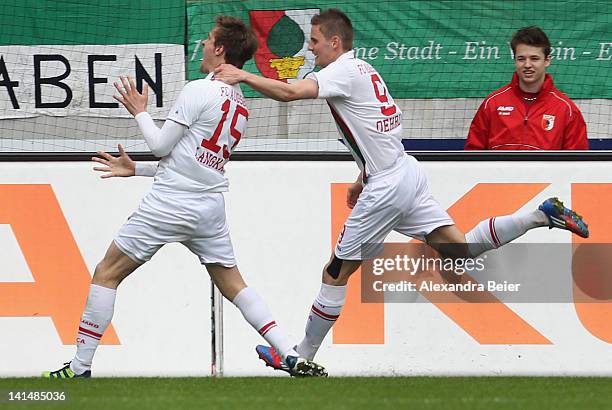 Sebastian Langkamp of Augsburg celebrates his first goal together with his teammate Torsten Oehrl during the German Bundesliga match between FC...