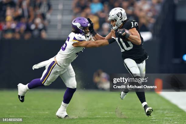 Mack Hollins of the Las Vegas Raiders stiff arms Troy Dye of the Minnesota Vikings during the first half of a preseason game at Allegiant Stadium on...