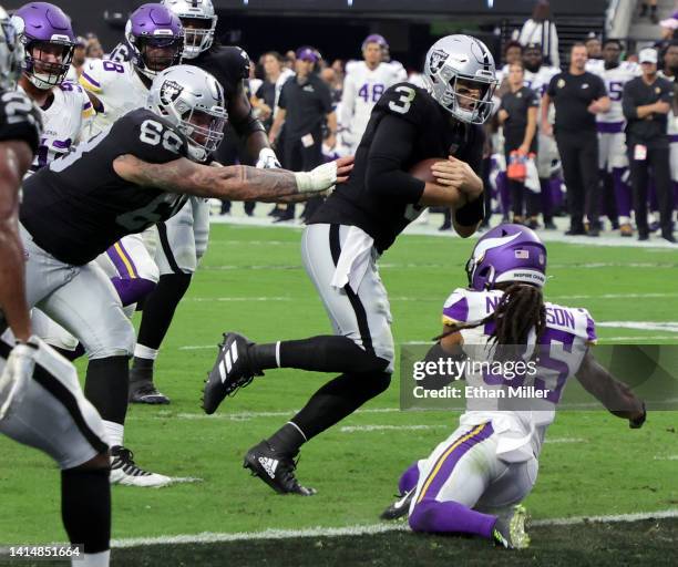 Quarterback Jarrett Stidham of the Las Vegas Raiders runs for a 4-yard touchdown against cornerback Parry Nickerson of the Minnesota Vikings with...