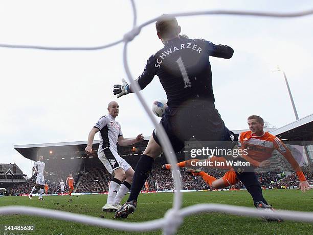 Gylfi Sigurdsson of Swansea shoots past Fulham goalkeeper Mark Schwarzer to score the opening goal of the Barclays Premier League match between...