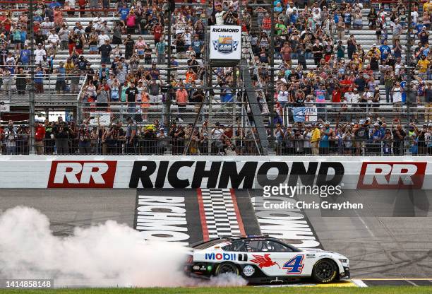 Kevin Harvick, driver of the Mobil 1 Ford, celebrates with a burnout after winning the NASCAR Cup Series Federated Auto Parts 400 at Richmond Raceway...