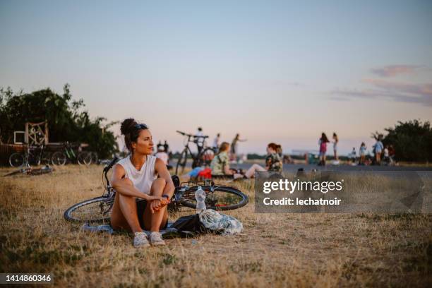 woman riding her bicycle in tempelhof, berlin - tempelhof airport stock pictures, royalty-free photos & images