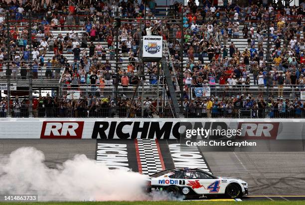 Kevin Harvick, driver of the Mobil 1 Ford, celebrates with a burnout after winning the NASCAR Cup Series Federated Auto Parts 400 at Richmond Raceway...