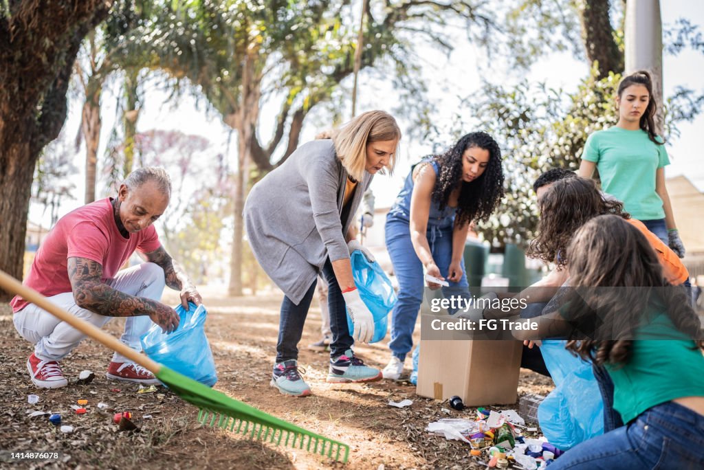 People picking up garbage to clean a public park