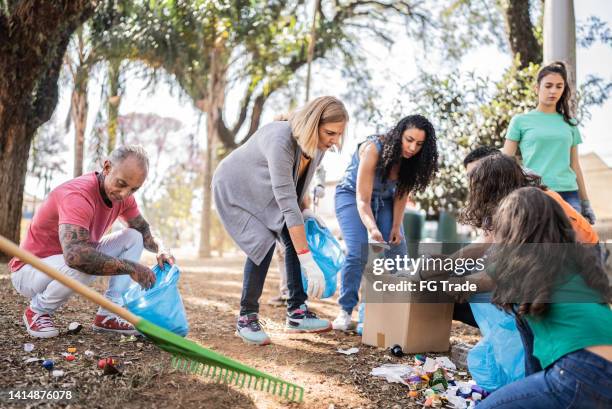 Black Man Picking Up Trash In Own Yard
