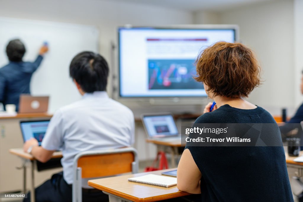 Mid adult woman in a continuing education class at a community college or university