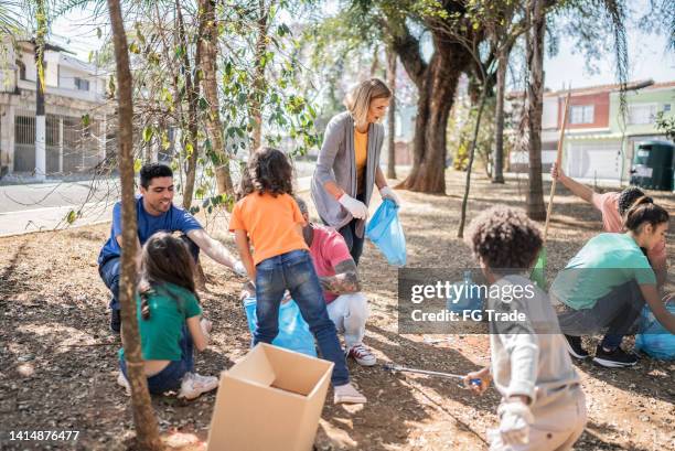 people picking up garbage to clean a public park - school district stock pictures, royalty-free photos & images