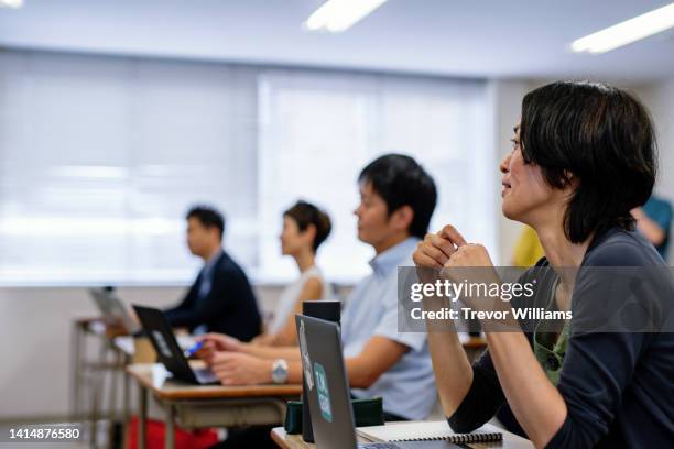 mature woman in a continuing education class at a community college or university - セミナー　日本人 ストックフォトと画像