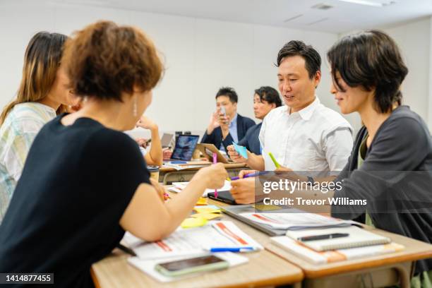 mid adult man in a continuing education class at a community college or university - セミナー　日本人 ストックフォトと画像