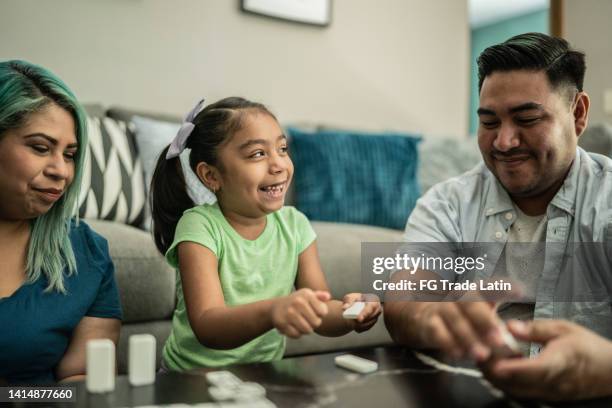 family playing domino and having fun at home - six game stock pictures, royalty-free photos & images