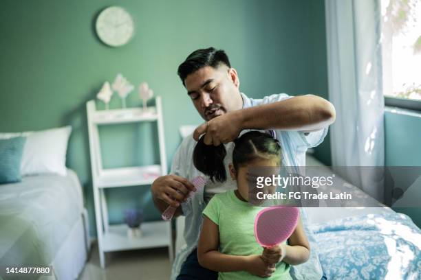 father combing daughter's hair at home - adjusting hair stock pictures, royalty-free photos & images